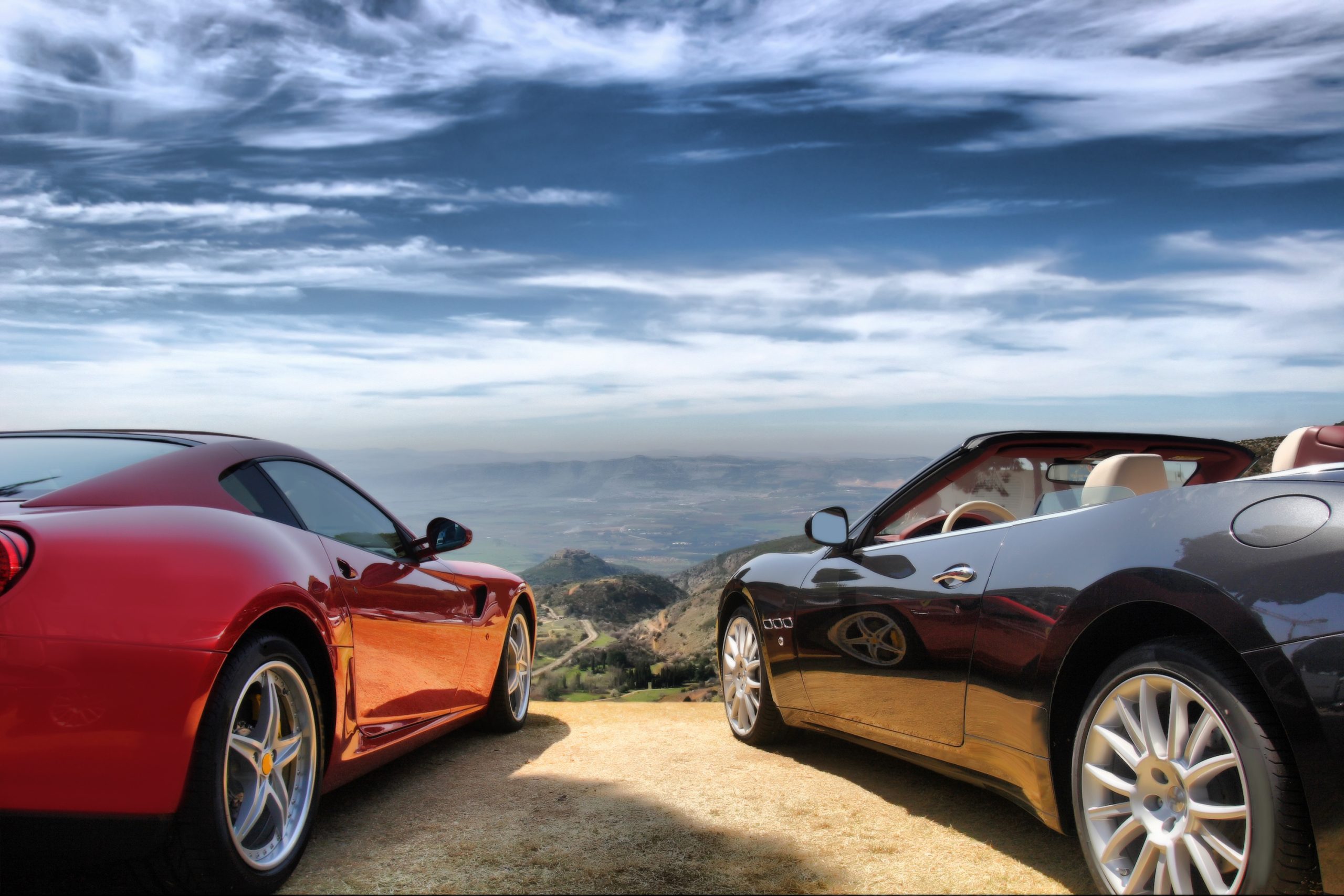 Luxury cars parked on scenic overlook