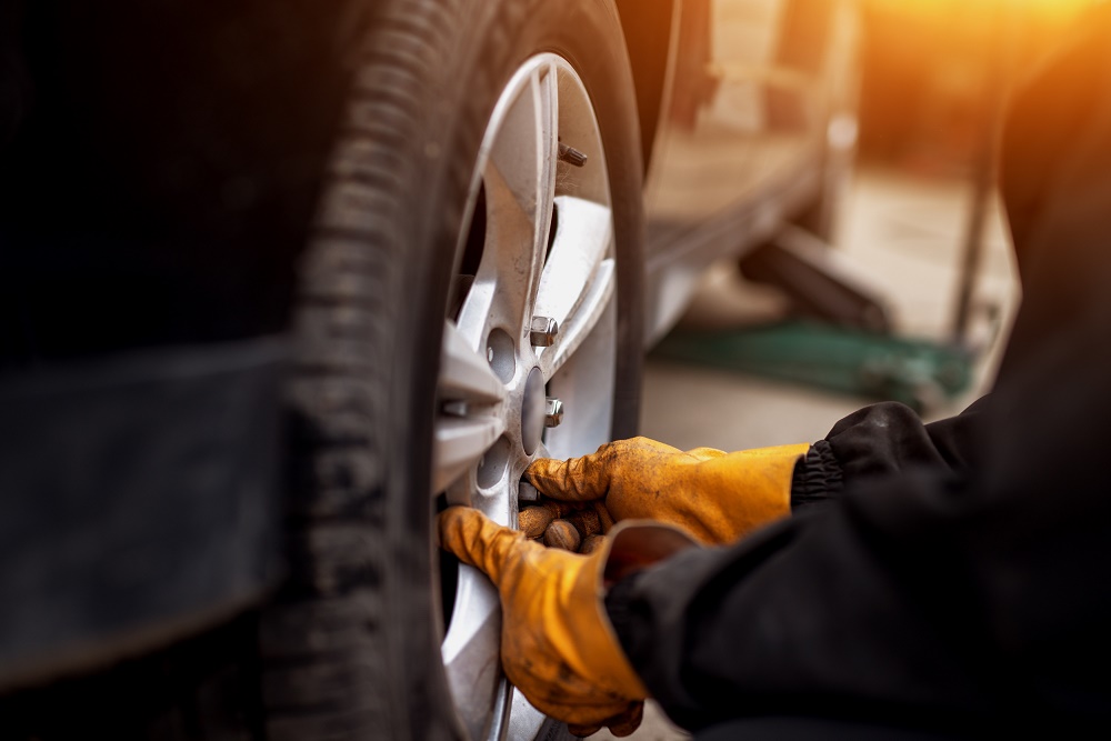 Man Performing a Tire Rotation