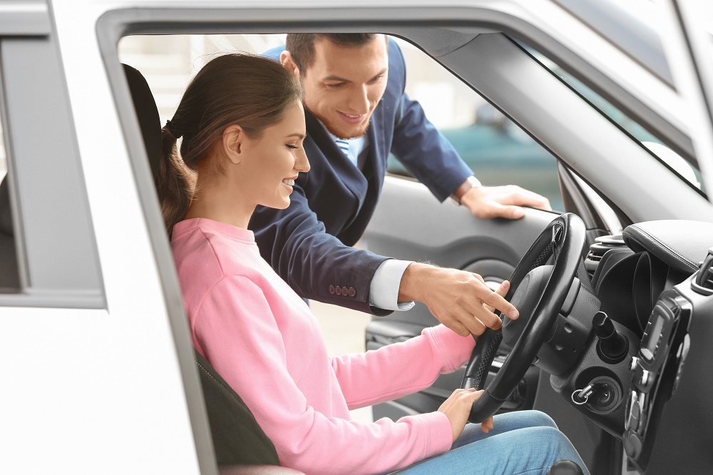 Woman Buying a New Luxury Car at Dealership in Houston, TX