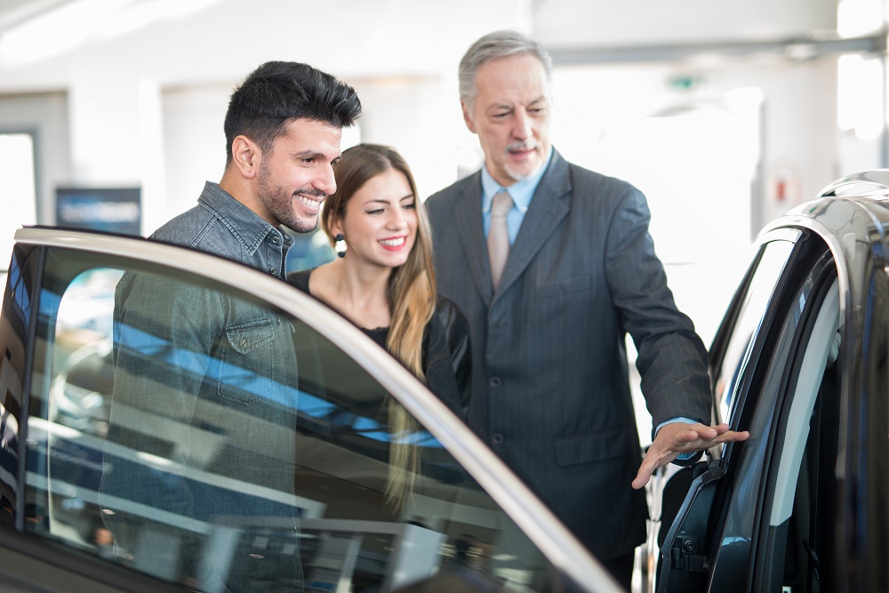 Dealer showing couple car