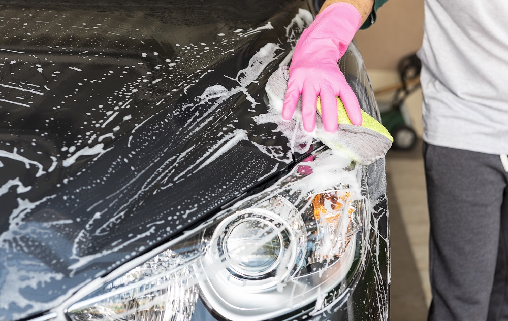 Man Cleaning Luxury Car in Houston, TX