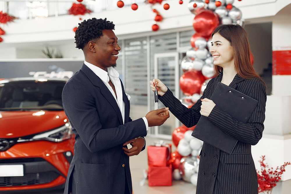 Man Buying Car at Used Car Dealership in Houston, TX