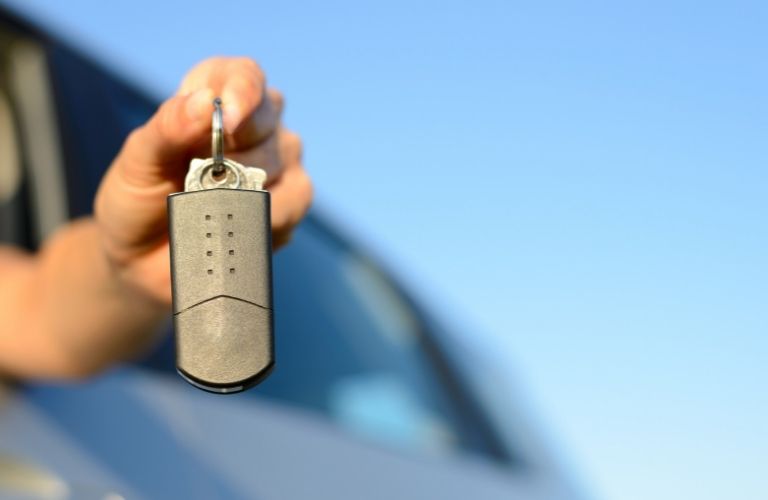 A person showing off car keys